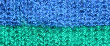 Pattern fabric made of wool. Handmade knitted fabric blue and turquoise wool background texture