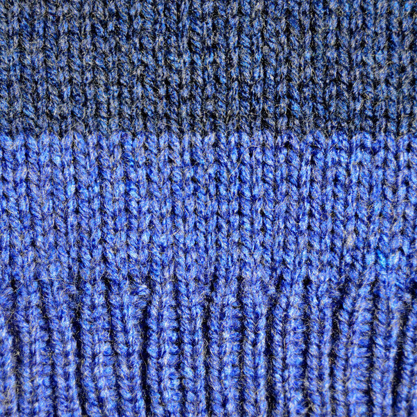 Pattern fabric made of wool. Handmade knitted fabric blue wool background texture