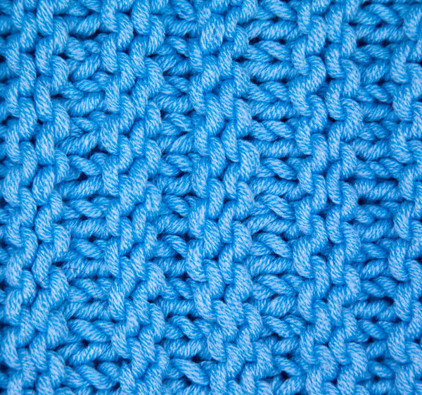 Pattern fabric made of wool. Handmade knitted fabric blue wool background texture