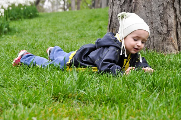 Dítě hrající na trávě — Stock fotografie