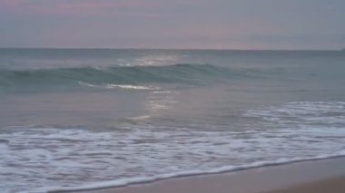 Gün batımında kıyıda dalgalar