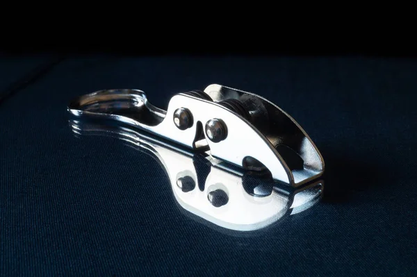 Sharpening the knife from steels rests upon turn blue the table with reflection. Kitchen accesories on black background