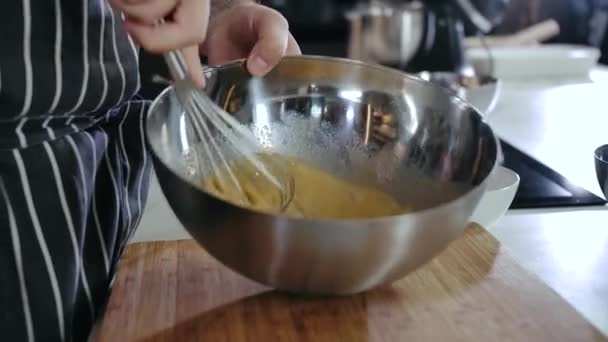 閉じる男の手シェフ料理4kのスチールボウルウィスクで食品成分を混合 — ストック動画