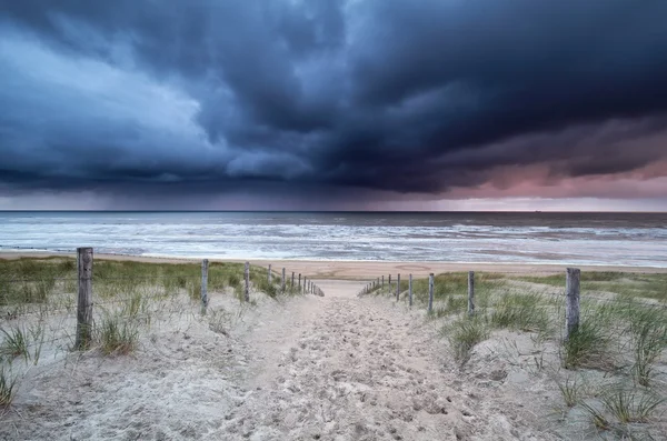 Stormy sky and showers over North sea beach — Stock Photo, Image