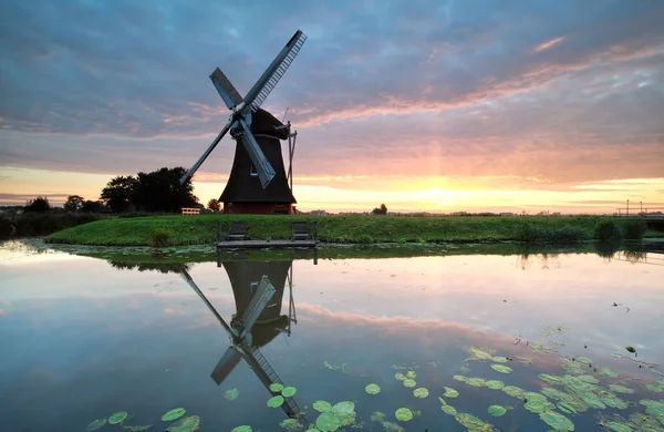 Zonsopgang op Nederlandse landbouwgrond met windmolen — Stockfoto