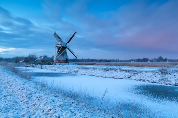 Winter sunrise over windmill in snow — Stock Photo, Image