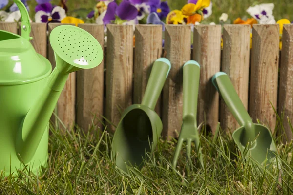 Gardening tools on the grass in the garden — Stock Photo, Image