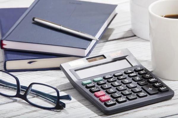 Mix of office supplies and gadgets on a wooden table background. view from above — Stock Photo, Image