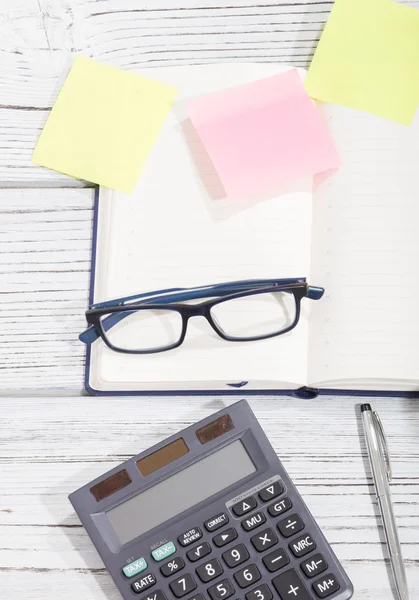 Mix of office supplies and gadgets on a wooden table background. view from above — Stock Photo, Image