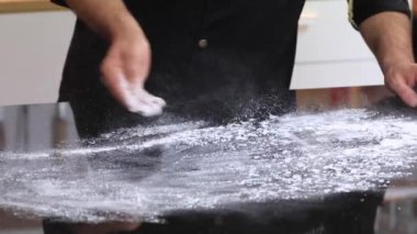 Profesyonel bir mutfakta deneyimli bir şef hamuru un ile hazırlar.. 