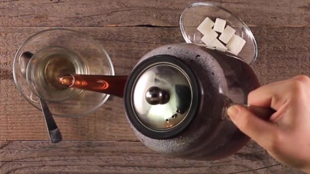 Verter el té de una tetera en una taza — Vídeo de stock
