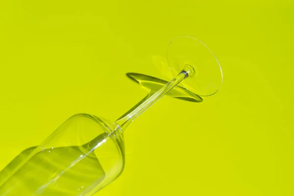 A pezsgős üveg egy része világoszöld felületen fekszik. Üveg kemény árnyékkal — Stock Fotó