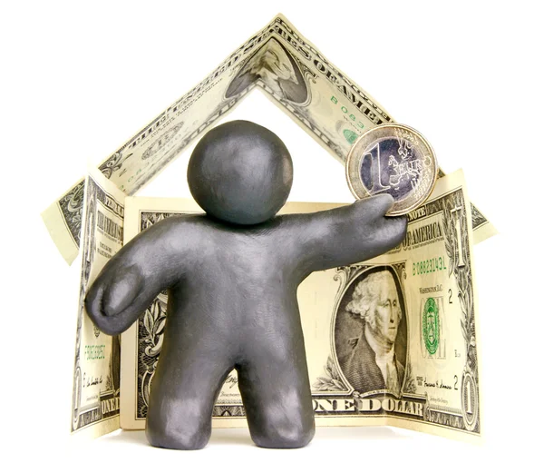 Plasticine man in the house of banknotes — Stock Photo, Image