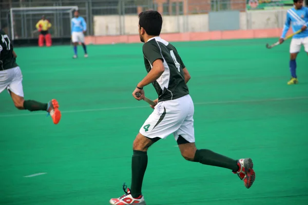 Landhockey-spelare kör — Stockfoto