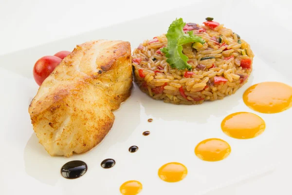 Chilean fish sea bass with a rice and tomato — Stock Photo, Image