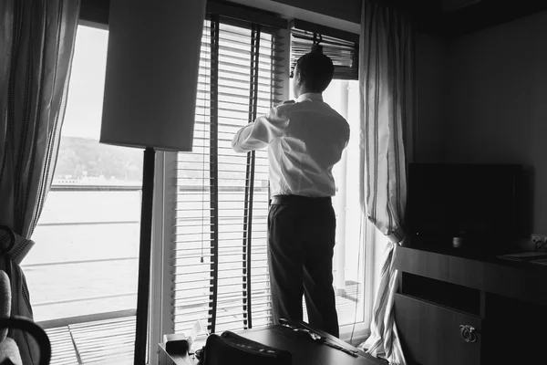 Black and white portrait of stylish businessman looking out of w — Stock Photo, Image