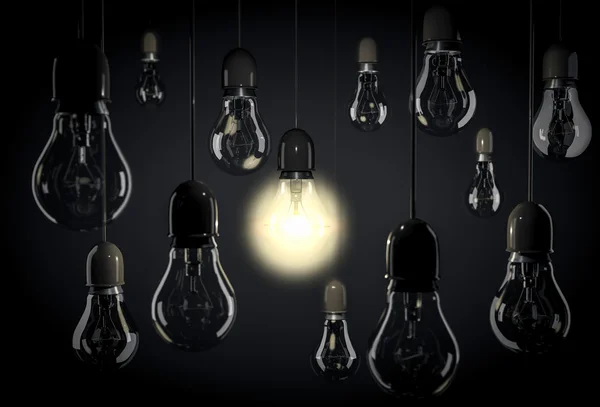 Hanging light bulbs on wires in blackroom — Stock Photo, Image