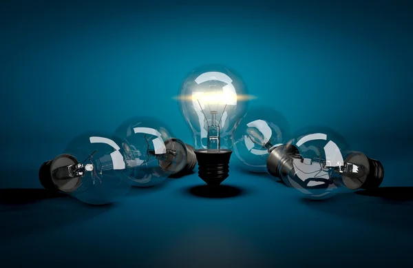 Concept of leadership. Glowing light bulb among dark ones lying — Stock Photo, Image