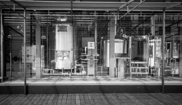 Black and white shot of big cisterns and pipes in brewery — Stock Photo, Image