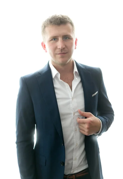 Stylish young man in blue suit posing against big window — Stock Photo, Image