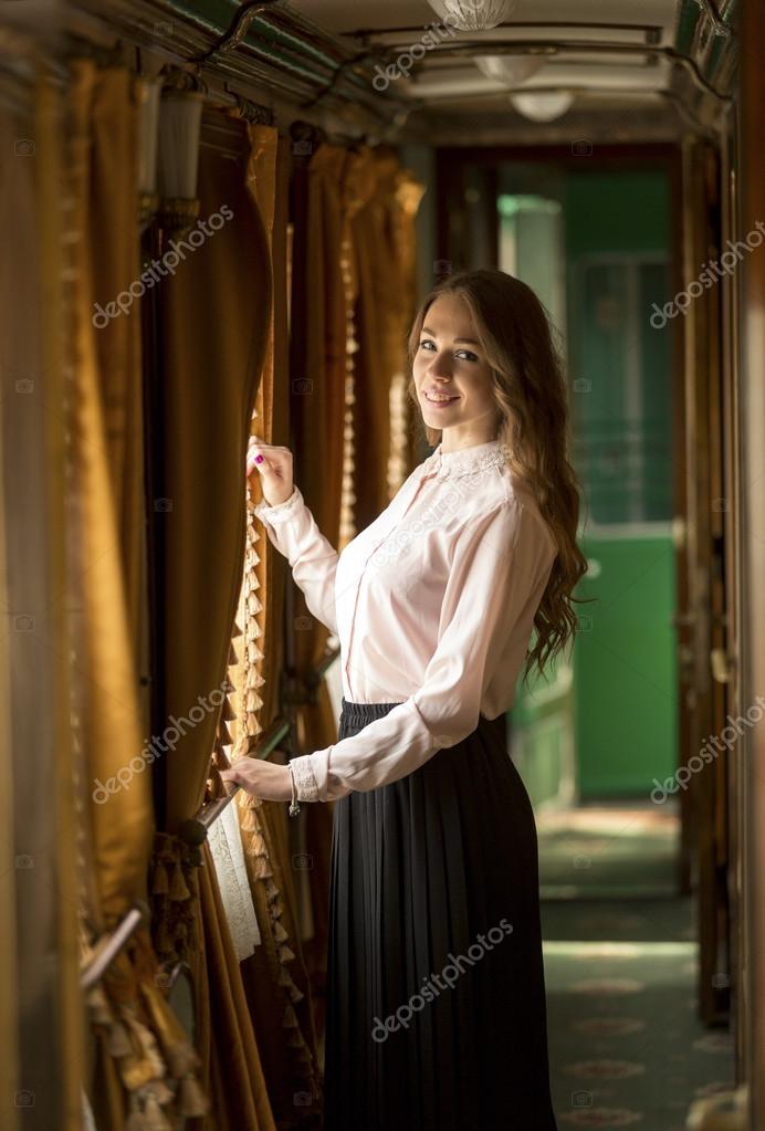 Elegant young woman looking out of train window