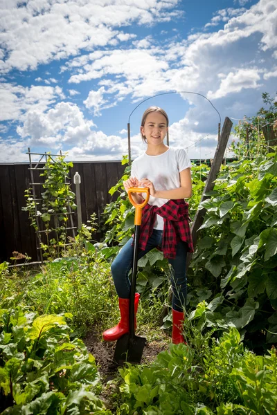 Teenage girl working at garden at bright sunny day — Stock Photo, Image
