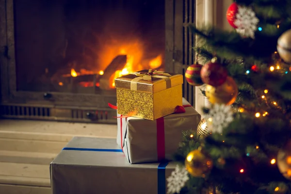 Toned image of Christmas tree and stack of presents in front of — Stock Photo, Image