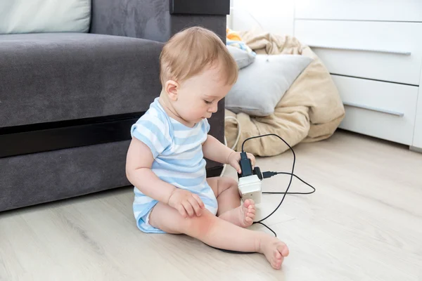 Concept of parent irresponsibility. Baby sitting alone in room a — Stock Photo, Image