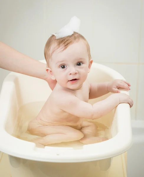 Adorable baby boy with foam on head having bath time — Stock Photo, Image