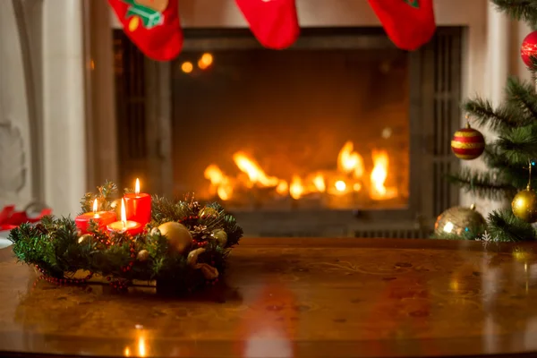 Christmas background with burning candles on wooden table in fro — Stock Photo, Image