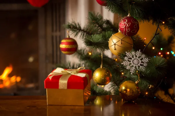 Closeup image of Christmas gift box with golden ribbon next to d — Stock Photo, Image