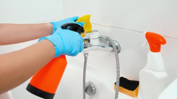 Κλείσιμο νοικοκυράς με χρήση ψεκασμού χημικού απορρυπαντικού και σφουγγαριού για καθαρισμό βρύσης μεταλλικού νερού στο μπάνιο — Αρχείο Βίντεο