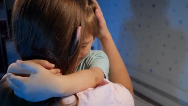Портрет маленького расстроенного и грустного мальчика, обнимающего и целующего свою мать перед сном. Любящие и заботливые родители и дети — стоковое видео
