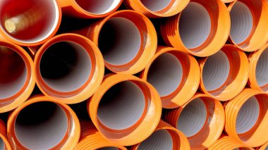 Fabrika deposuna yerleştirilmiş PVC boruları ve borular nakil için hazır.