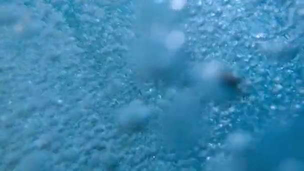 Closeup slow motion of lots of air bubbles floating up to the water surface in swimming pool. Beautiful underwater background or backdrop. — Stock Video