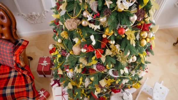 Hermosa foto panorámica del árbol de Navidad y regalos en cajas de Santa Claus en la sala de estar durante las vacaciones de invierno. Fondo o telón de fondo de vacaciones de invierno. — Vídeo de stock