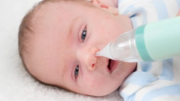 Zbliżenie powolny ruch czyszczenia malutki nos noworodka z elektrycznym aspiratorem. Pojęcie niemowląt i higieny noworodków oraz opieki zdrowotnej. Opieka rodziców z małymi dziećmi. — Wideo stockowe