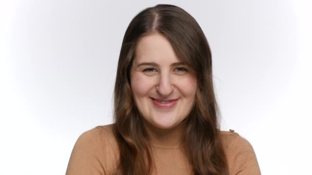 Portrait of smiling young woman looking in camera and winking with eye. — Stock Video