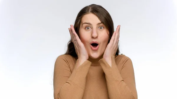 Beautiful cute woman gets surprised and shakes head. Positive emotions and surprised face expression — Stock Photo, Image