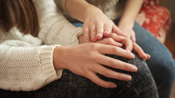 Closeup of teenage girl stroking her friends hands. Friends support and teenager depression — Stock Photo, Image