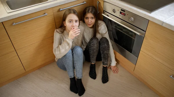 Two girls hiding from aggression or anger of parent. Concept of domestic violence and family aggression — Stock Photo, Image