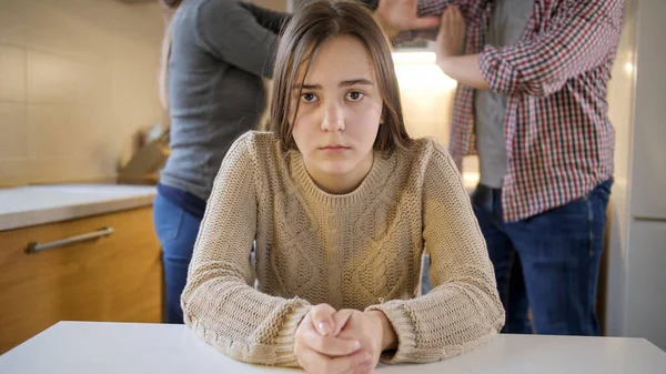 Upset teenage girl got stressed and depressed because or shouting and arguing parents. Family violence, conflicts and relationship problems — Stock Photo, Image