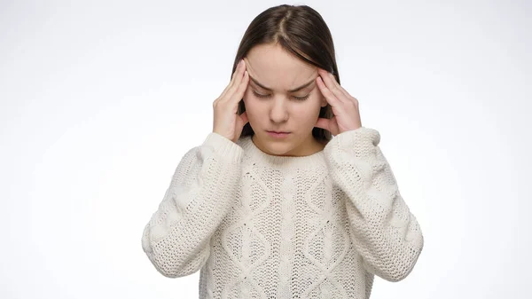 Studio portrait of young girl suffering from headache and rubbing temples. — Stock Photo, Image