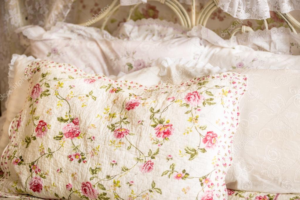photo of pillow with floral print on big bed