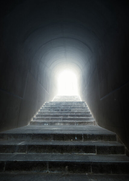 staircase in the tunnel with light at the end