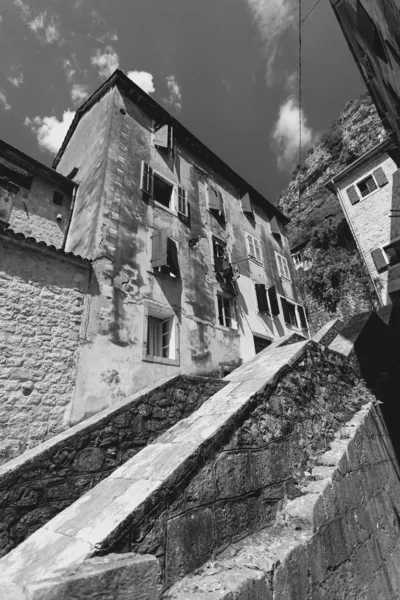 Monochrome photo of big stairway at old city with narrow streets — Stock Photo, Image