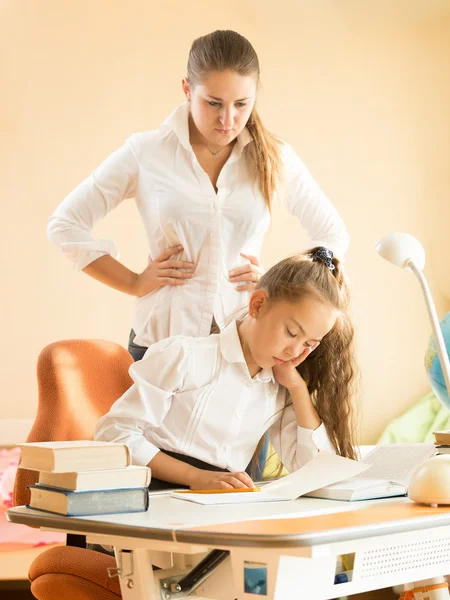 Mother being angry of daughter sleeping on desk while doing home — Stock Photo, Image