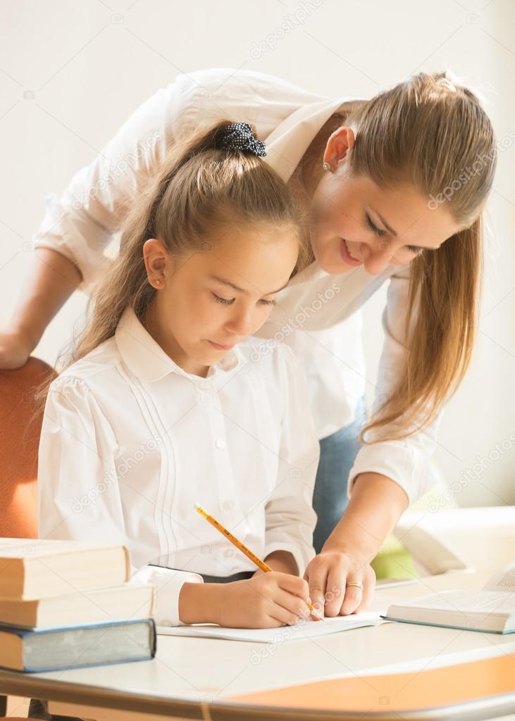 mother helping daughter with preparing to exam