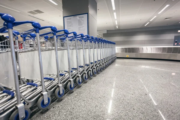 Багажные тележки в терминале прибытия в аэропорту — стоковое фото