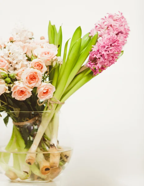 different flowers standing in glass vase